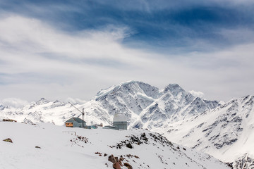 Fototapeta na wymiar Panorama of the main Caucasus ridge and peak Terskol with Observatory in the foreground