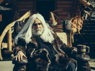 Old druid with wooden mug