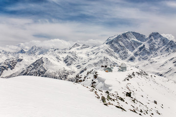 Fototapeta na wymiar Panorama of the main Caucasus ridge and peak Terskol with Observatory in the foreground