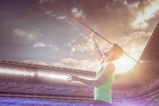 Composite image of athletic man throwing a javelin