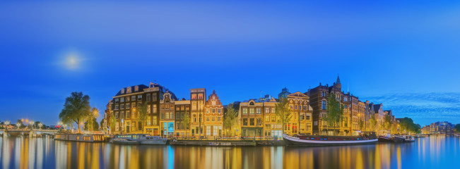 Obraz premium Amstel river, canals and night view of beautiful Amsterdam city. Netherlands