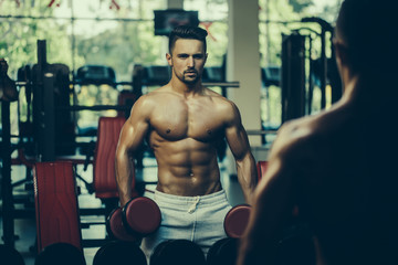 Naklejka premium muscular man with dumbbell