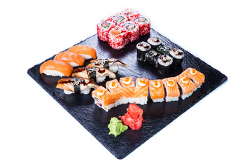 Sushi Set  and sushi rolls on black stone slate. Restaurant food concept.