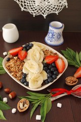 granola with banana, strawberry and blueberry for a healthy breakfast 