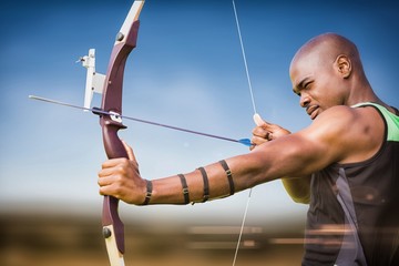 Composite image of side view of sportsman practising archery 