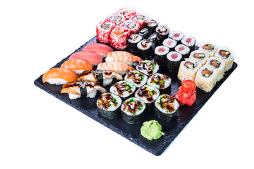 Sushi Set  and sushi rolls on black stone slate. Restaurant food concept.