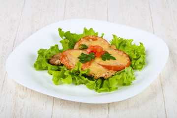 Pork baked with tomato and cheese