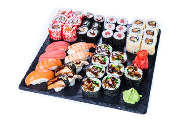 Sushi Set  and sushi rolls on black stone slate. Restaurant food concept.