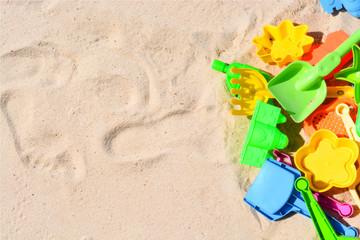 Colorful beach toys in sand