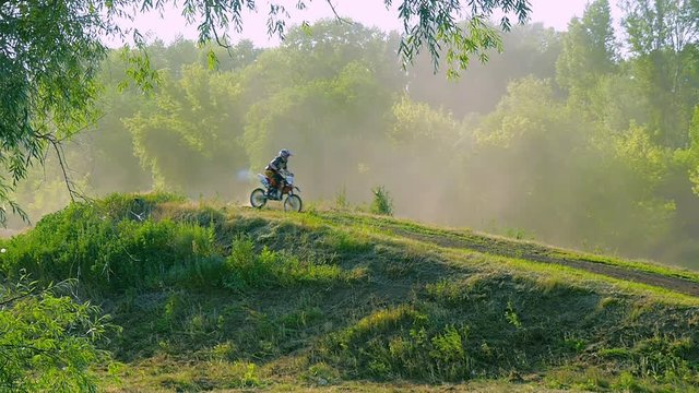 extreme sports motocross motorcycle jumping on a race on high speed rail amped through mud super slow motion racers fly over jump freestyle stunt