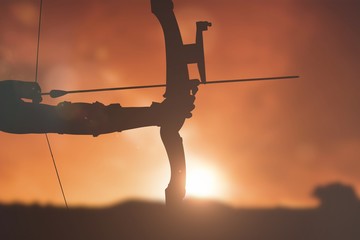 Composite image of close up of someone practising archery 