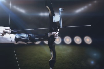 Composite image of close up of someone practising archery 