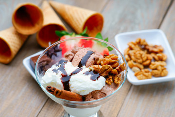 Ice cream sundae, waffle cones, walnuts and strawberry