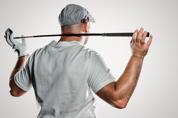 Composite image of rear view of golf player holding a golf club