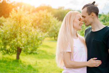 Couple standing in park and hugging