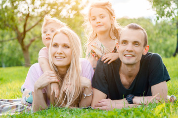 Young family lying on grass in countryside