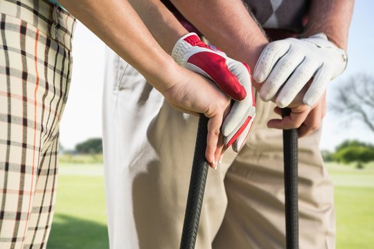 Composite image of hands holding golf club