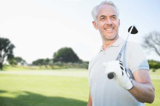 Composite image of man holding a golf club