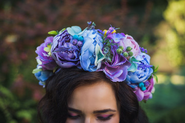 Attractive young woman with blue flowers crown