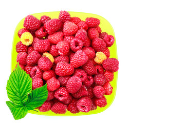 Bowl full of ripe raspberries isolated on white background.