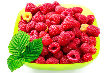 Bowl full of ripe raspberries isolated on white background.