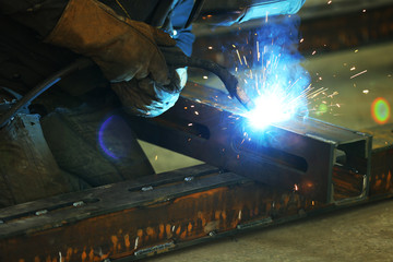 Man working with welding in the garage