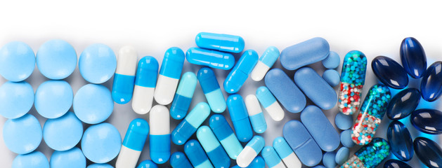 Blue pills isolated on white - obrazy, fototapety, plakaty
