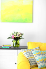 Vase with fresh roses in the room