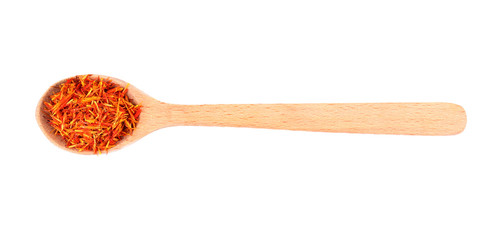Dried saffron in spoon on white background