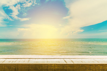 Fototapeta na wymiar Wood table top on sunrise sky and beach background