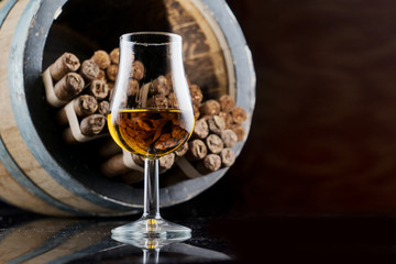 Handmade cigars are stored in a barrel of brandy soaked aroma