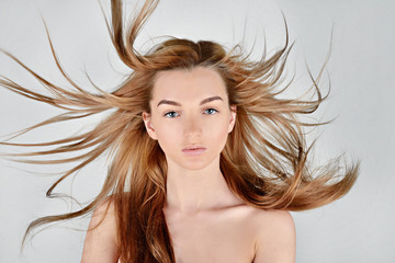 Female portrait of cute lady isolated on a white background. Close up beautiful sexy model girl in elegant pose. Closeup beauty blonde woman with hairstyle indoors