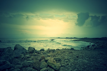 Gloomy rocky coast and stormy sea