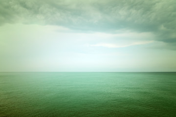 Moody green sea and clouds