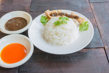 Rice and grill pork with sauce in side view