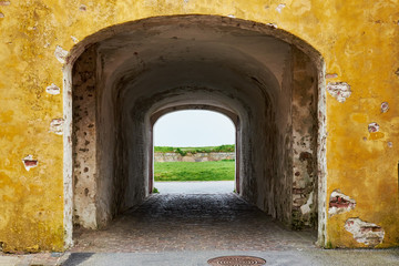 Entrance to an arched tunnel going through an historic storehous