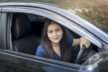 Fototapeta na wymiar Attractive business woman driving her car