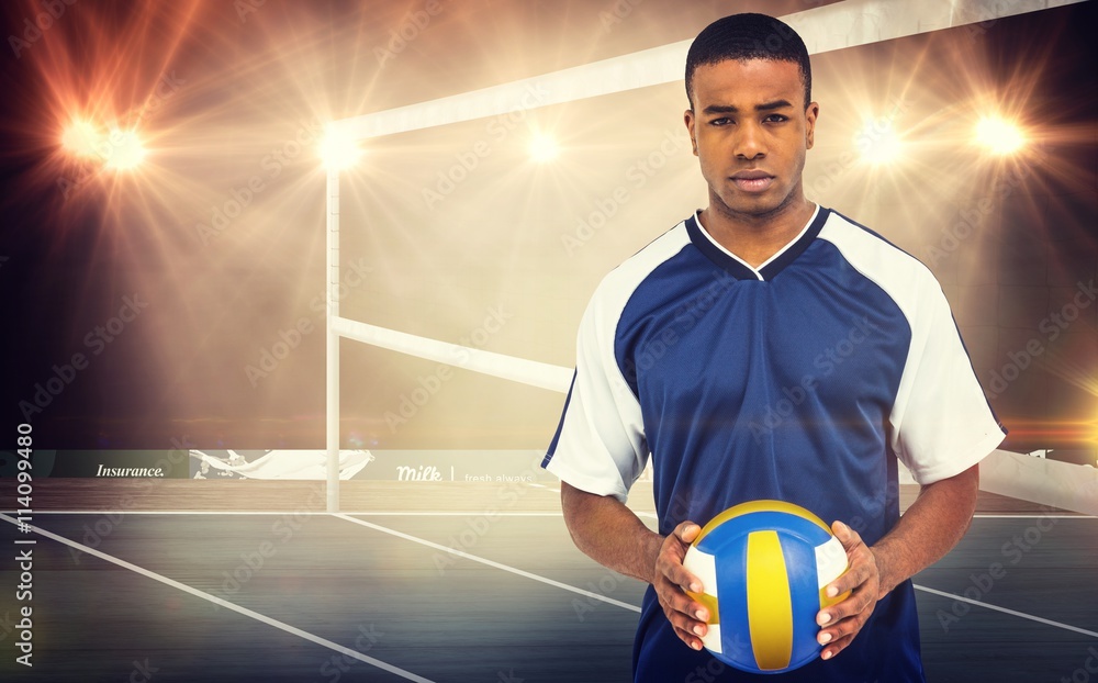 Wall mural Composite image of sportsman holding a volleyball