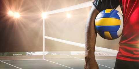Composite image of mid-section of sportsman holding a volleyball