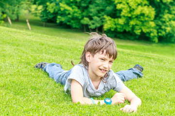 Adorable young child boy in the park. On warm summer day during