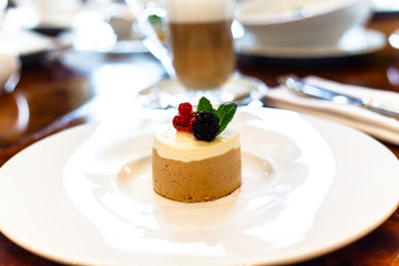 Coffee dessert with fresh berries lies on the plate.