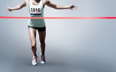 Composite image of sportswoman finishing her run