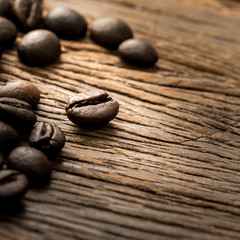 Roasted coffee bean on grunge wood background