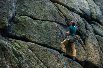 Men climbing vertical wall, Poland