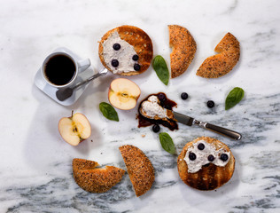 Fototapeta na wymiar Toasted bagels with cream cheese and dark coffee 