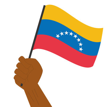 Hand holding and raising the national flag of Venezuela