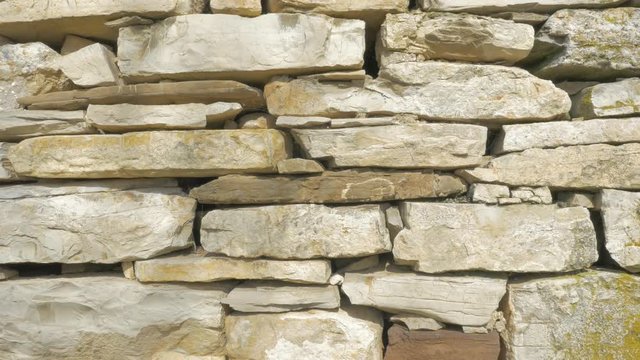 Stone plates arranged in wall slow tilting 4K 2160p UHD footage - Stone wall made of natural components 4K 3840X2160 UHD video 