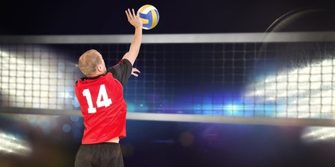 Composite image of rear view of sportsman hitting volleyball