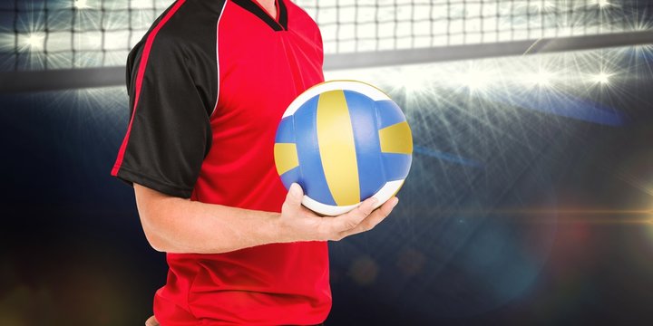 Composite image of sportsman holding a volleyball