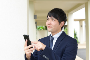 スマートフォンを持つ笑顔の男性